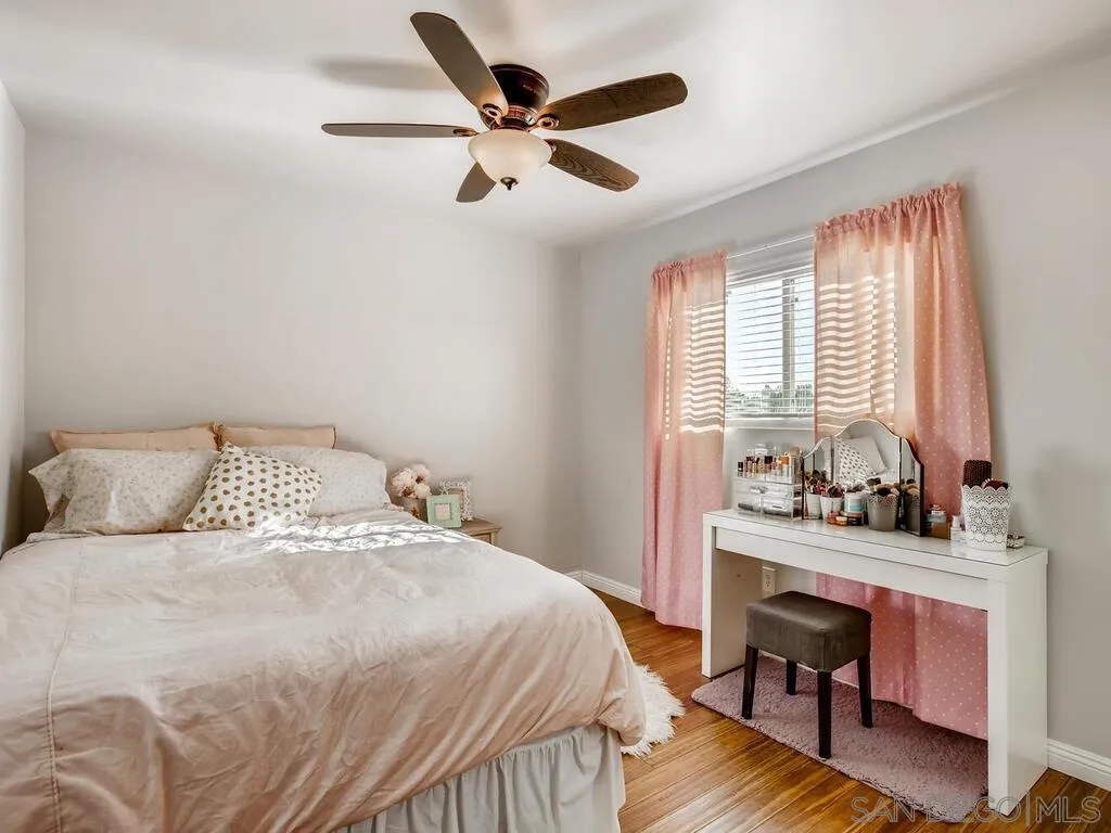 9559 Tuthill Way Santee, CA 92071 - Photo 12 of 27 a bedroom with a bed a dresser and a chandelier