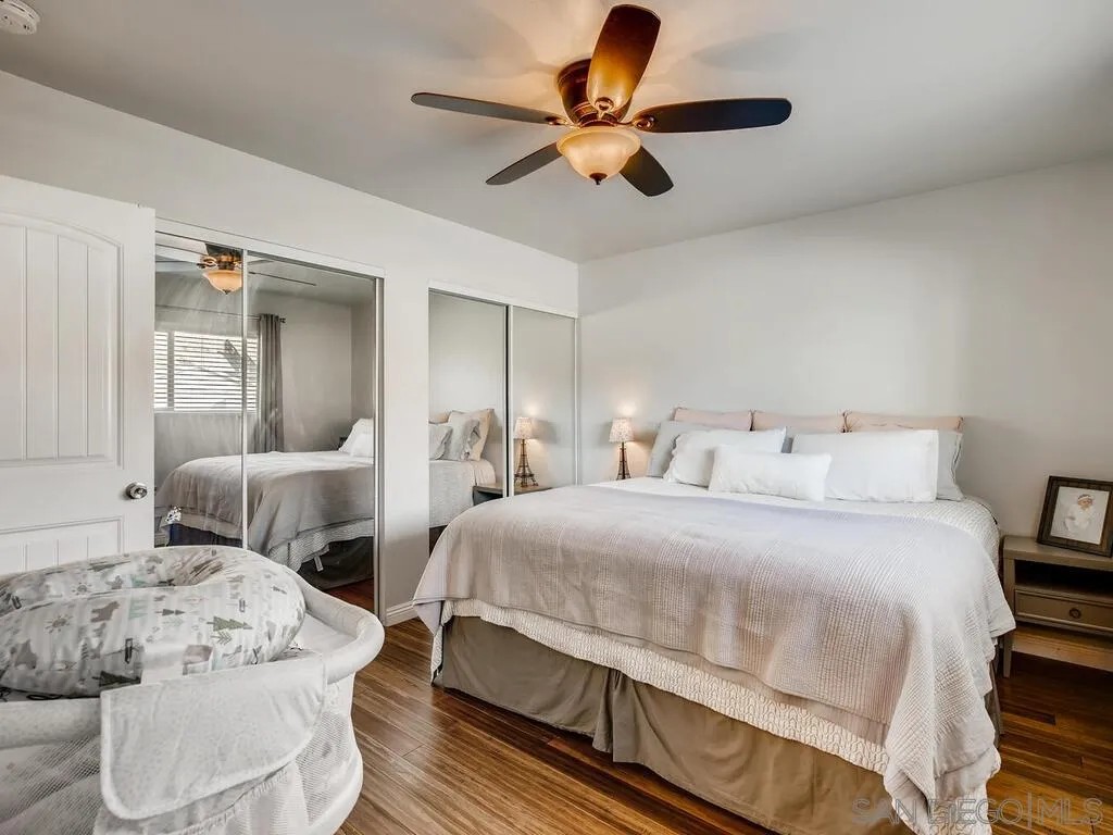 9559 Tuthill Way Santee, CA 92071 - Photo 18 of 27 a bedroom with a bed and a chandelier