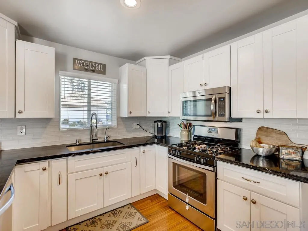 9559 Tuthill Way Santee, CA 92071 - Photo 21 of 27 a kitchen with granite countertop white cabinets white stainless steel appliances and sink