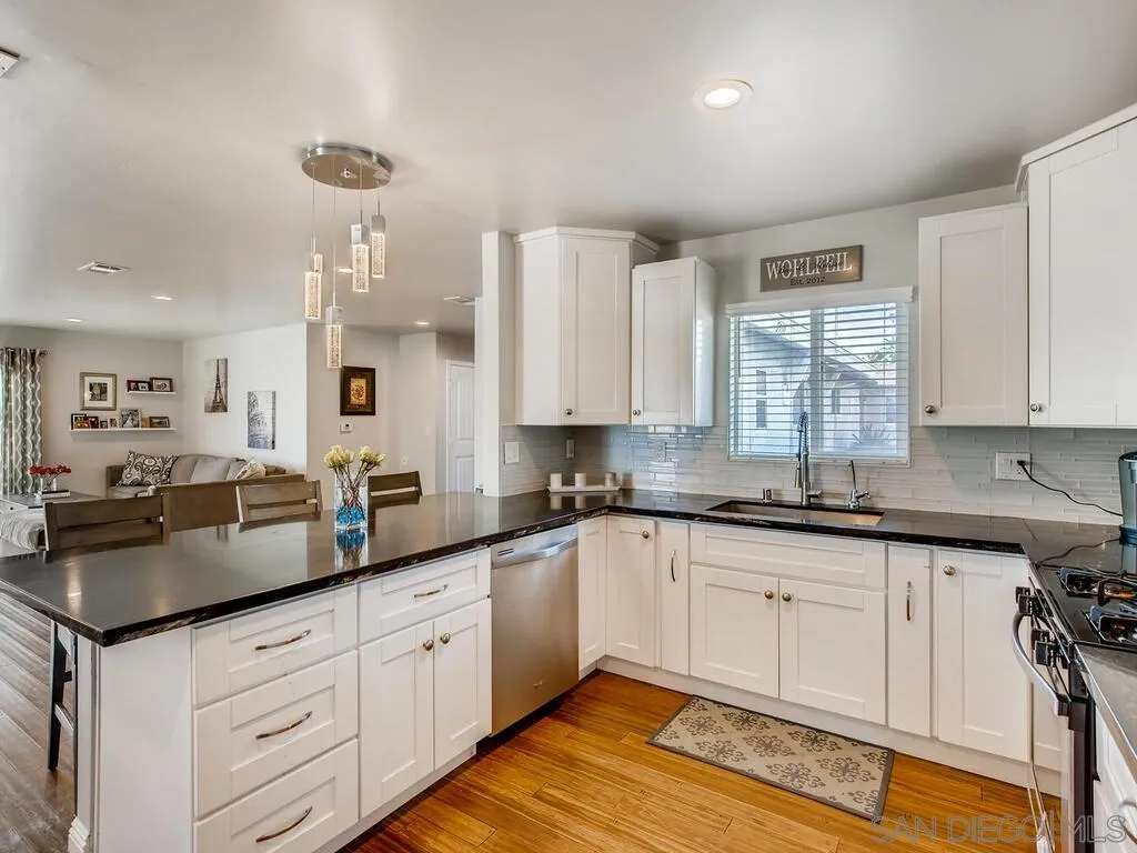 9559 Tuthill Way Santee, CA 92071 - Photo 22 of 27 a kitchen with granite countertop white cabinets and white appliances