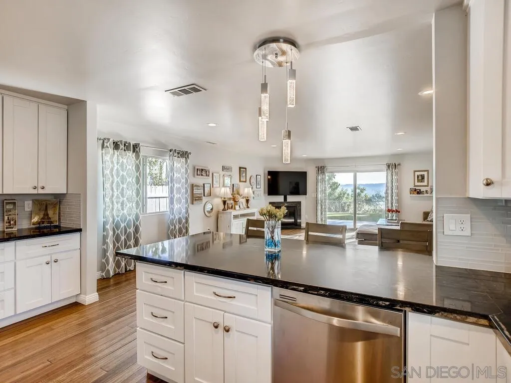 9559 Tuthill Way Santee, CA 92071 - Photo 6 of 27 a kitchen with granite countertop a sink counter top space cabinets and stainless steel appliances