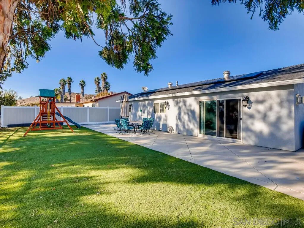 9559 Tuthill Way Santee, CA 92071 - Photo 8 of 27 a view of a house with backyard and a tree