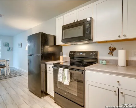 a kitchen with stainless steel appliances granite countertop a refrigerator stove and microwave
