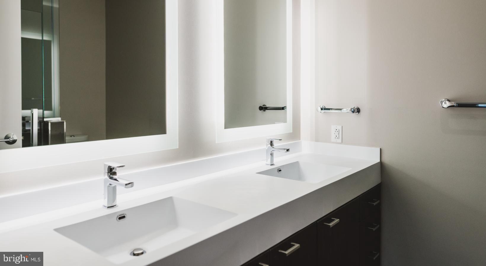 450 North 18th Street, Unit 2B0710 Philadelphia, PA 19130 - Photo 43 of 44 a bathroom with a sink and a mirror