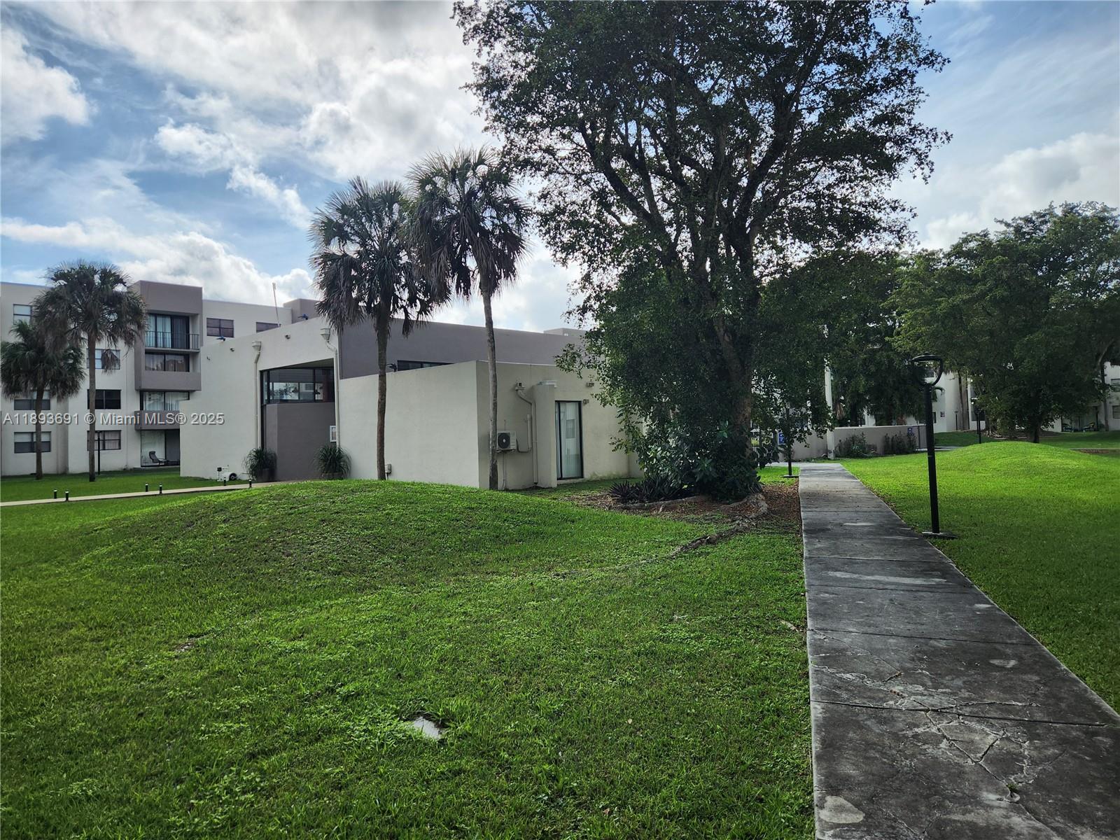 8000 Southwest 149th Avenue, Unit A107 Miami, FL 33193 - Photo 13 of 15 a backyard of a house with lots of green space