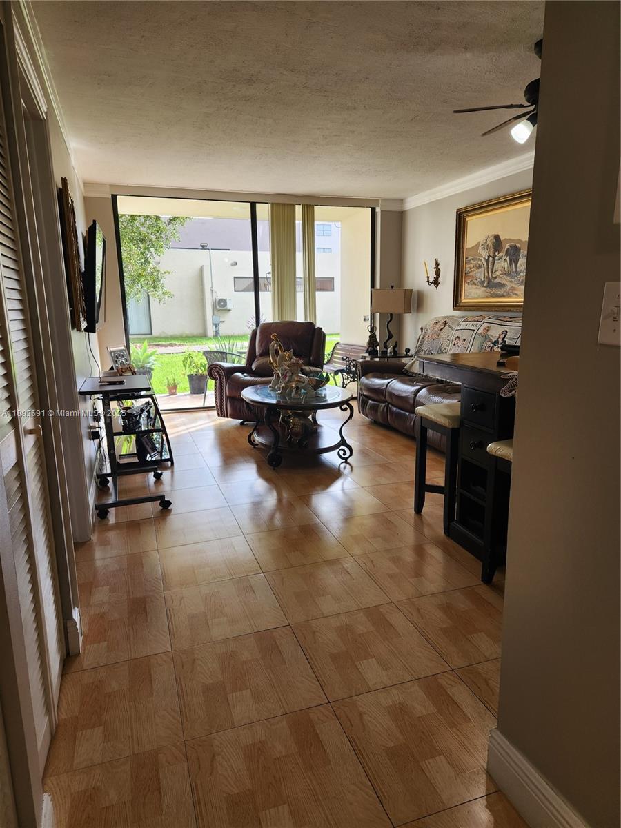 8000 Southwest 149th Avenue, Unit A107 Miami, FL 33193 - Photo 4 of 15 a living room with furniture and a flat screen tv