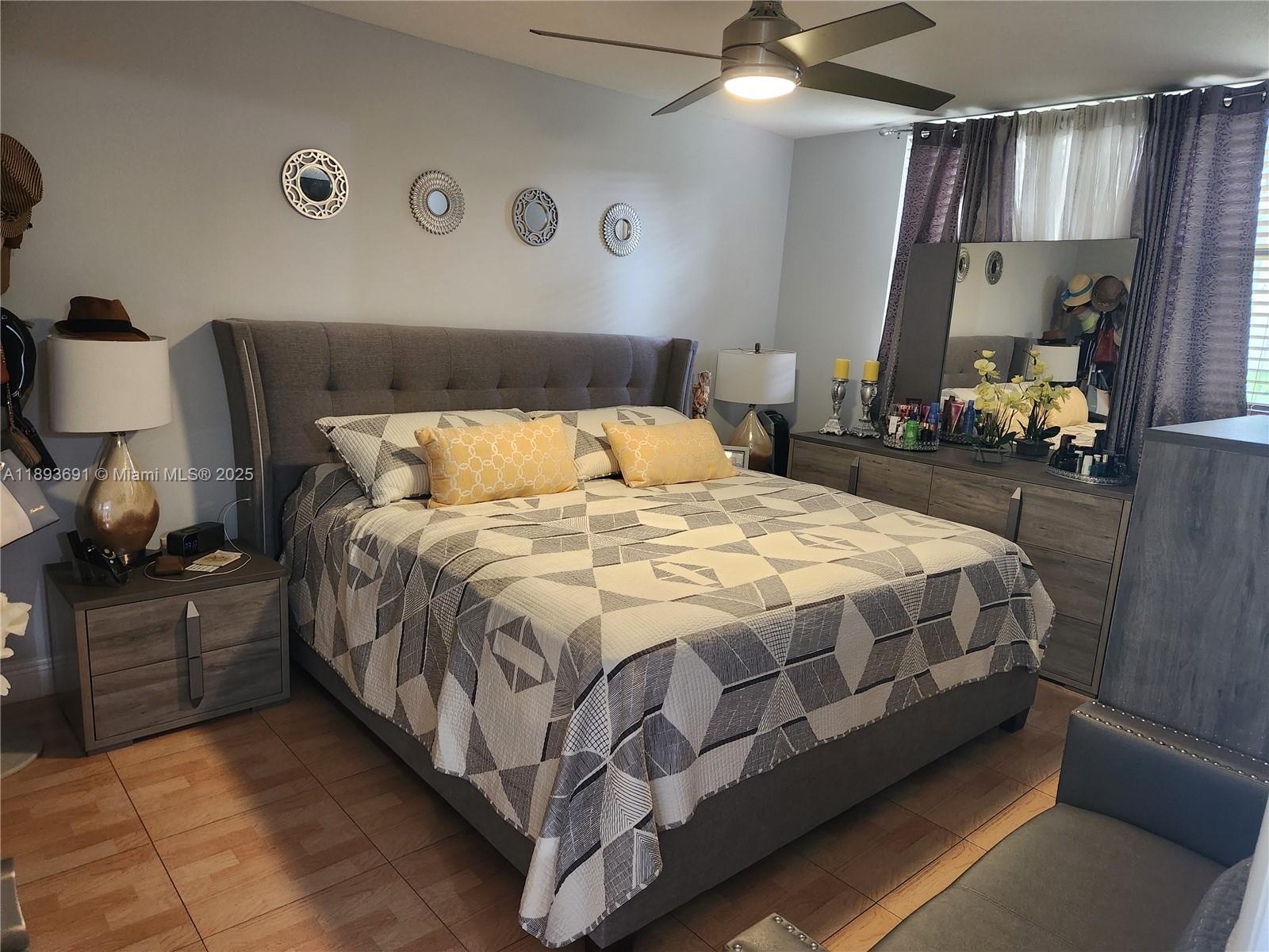 8000 Southwest 149th Avenue, Unit A107 Miami, FL 33193 - Photo 5 of 15 a bedroom with a bed and dresser with mirror