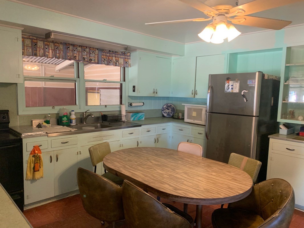 7975 Ulili Road Kekaha, HI 96752 - Photo 5 of 12 a kitchen with stainless steel appliances granite countertop a refrigerator a sink a stove and island