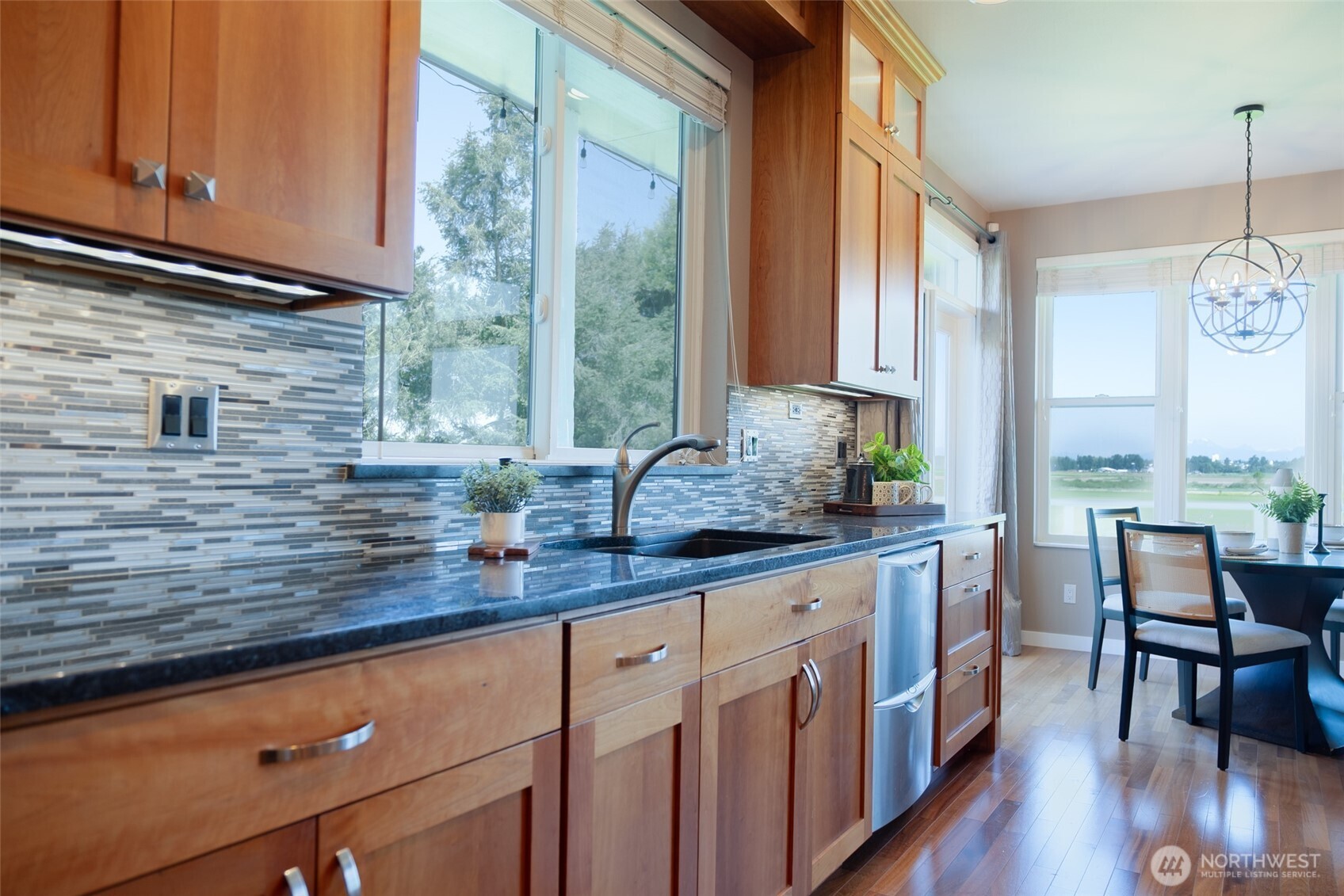 746 Van Dyk Road Lynden, WA 98264 - Photo 11 of 40 a kitchen with stainless steel appliances granite countertop a stove a sink and cabinets