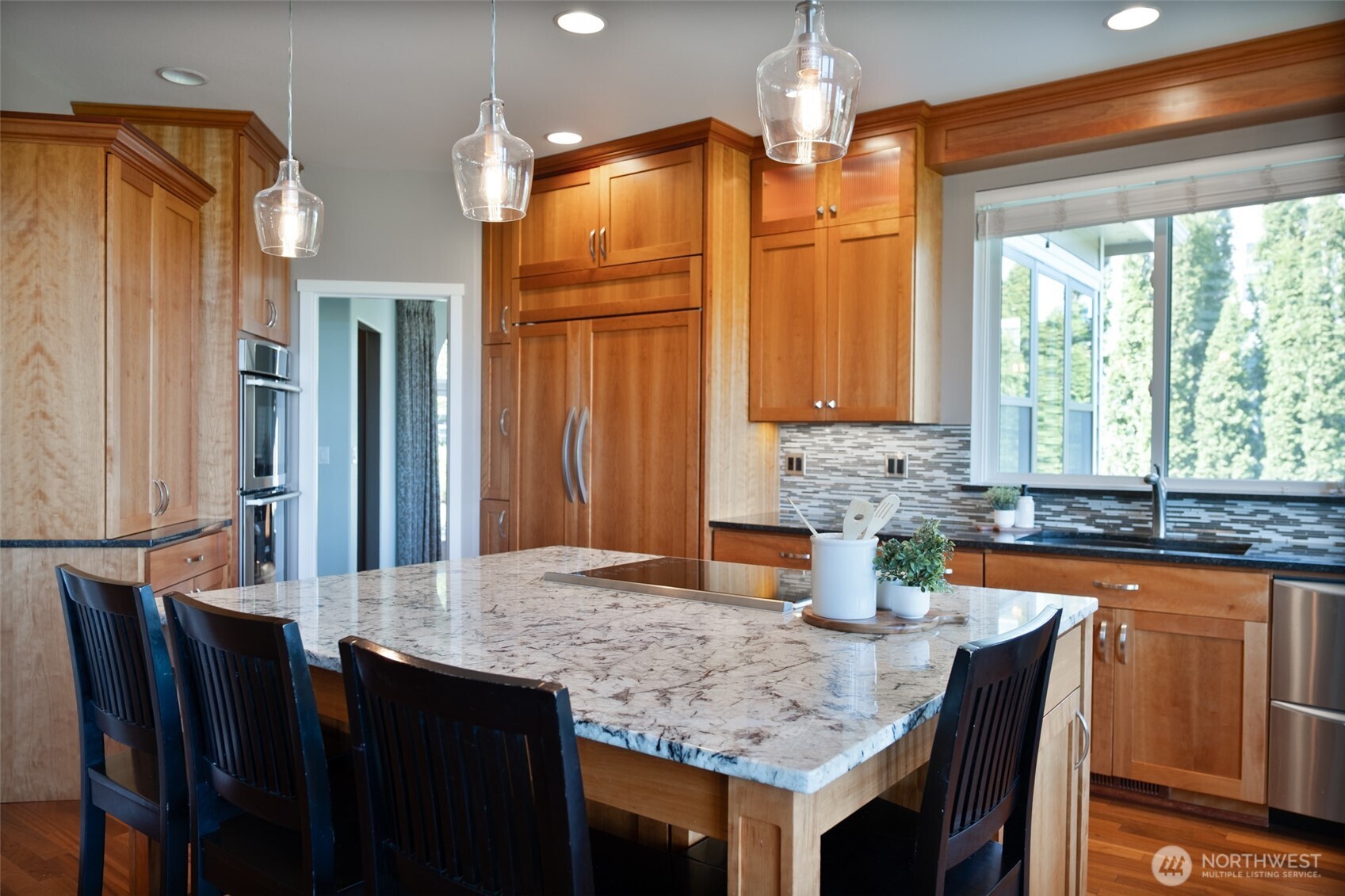 746 Van Dyk Road Lynden, WA 98264 - Photo 12 of 40 a kitchen with granite countertop a sink dining table and chairs