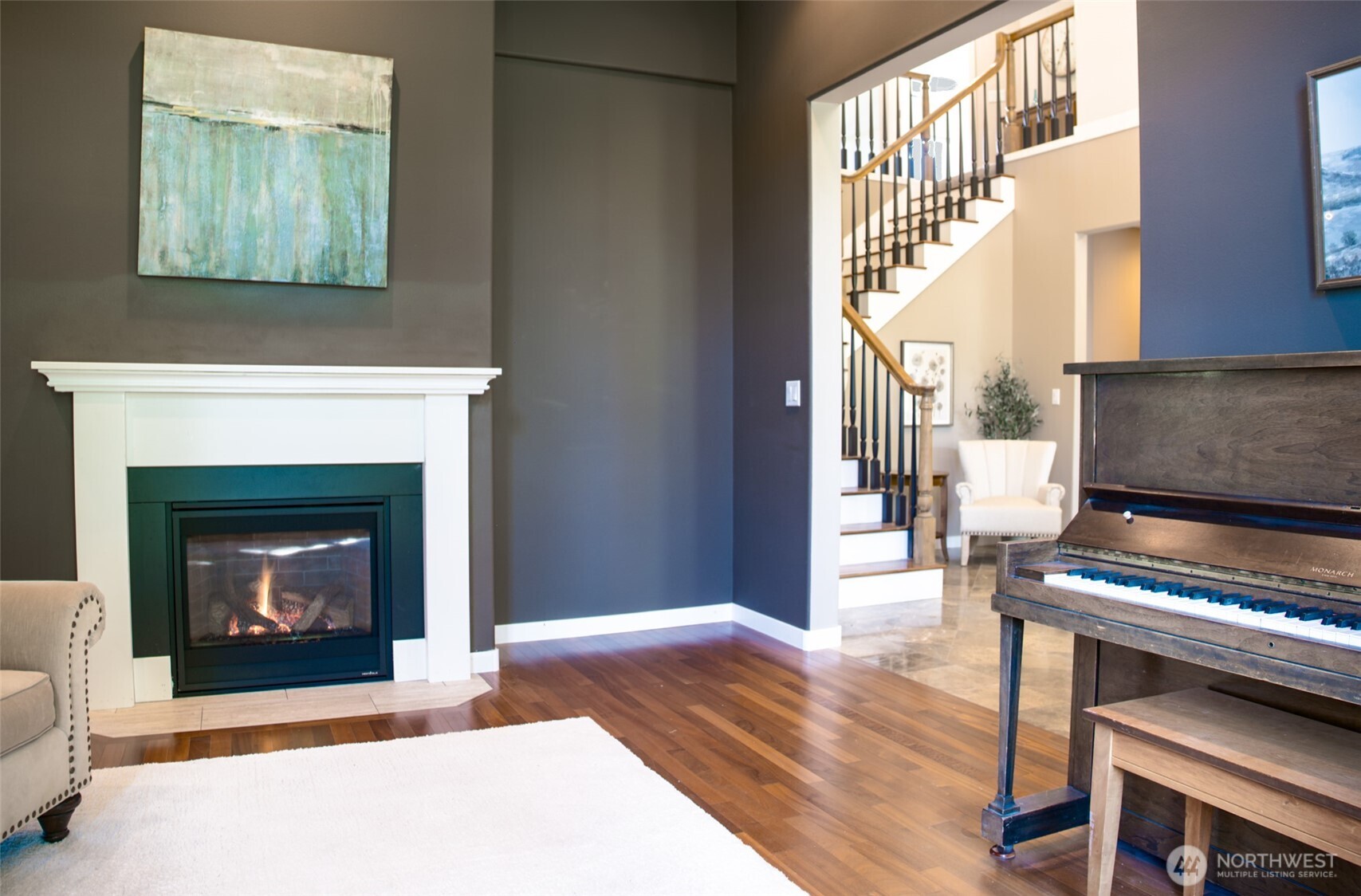 746 Van Dyk Road Lynden, WA 98264 - Photo 14 of 40 a living room with wooden floor a fireplace and a window