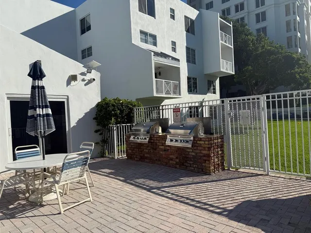 a view of a patio with couches table and chairs and potted plants
