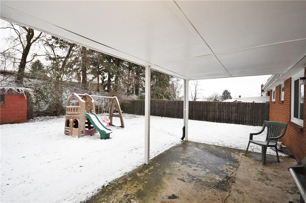 413 Grove Road Verona, PA 15147 - Photo 17 of 25 Covered back patio and fenced in yard. Swing set is buyer's preference. Stay or go!