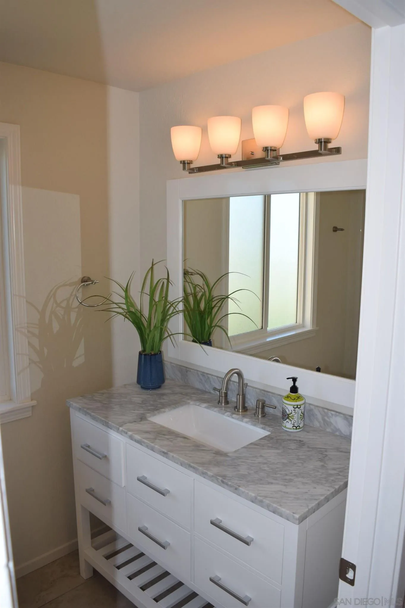 70 Trinidad Bend Coronado, CA 92118 - Photo 17 of 44 a bathroom with a granite countertop sink and a mirror
