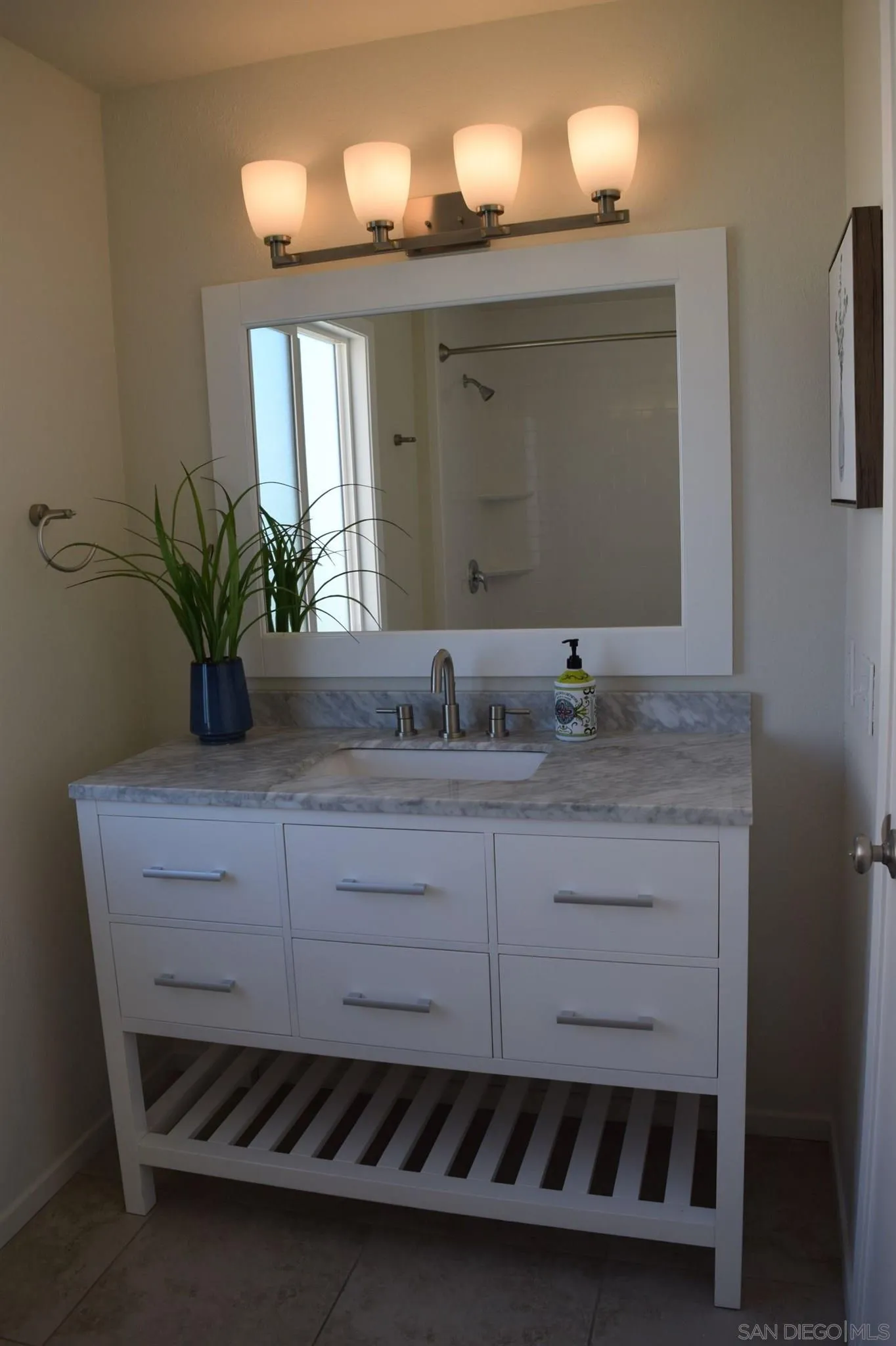 70 Trinidad Bend Coronado, CA 92118 - Photo 18 of 44 a bathroom with a sink a potted plant and a mirror