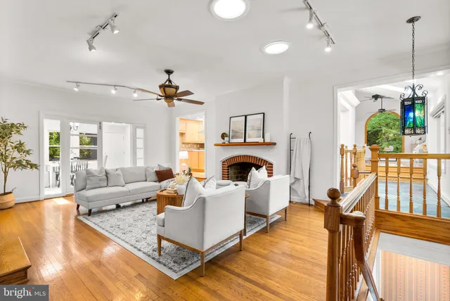 a living room with furniture a fireplace and a chandelier