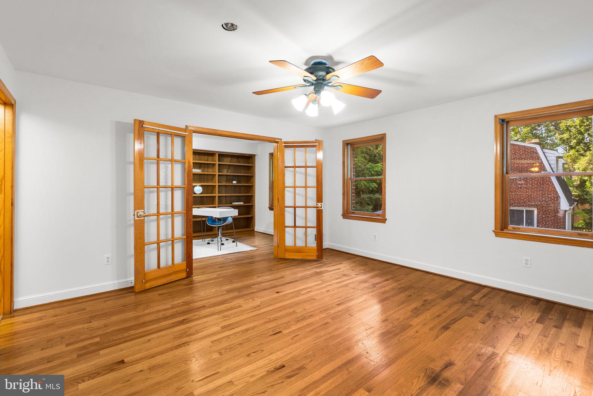 2816 Linden Lane Silver Spring, MD 20910 - Photo 19 of 62 a view of an empty room with a window and wooden floor