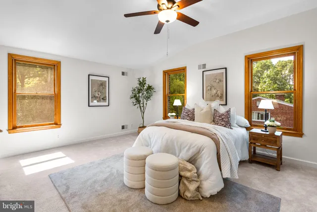 a bedroom with a bed and a large window