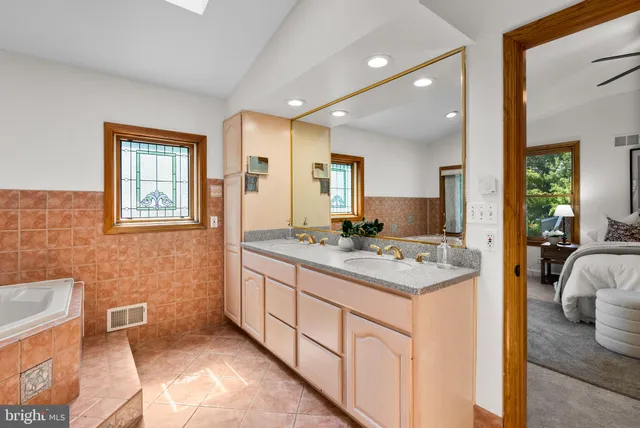an empty room with a window and a ceiling fan