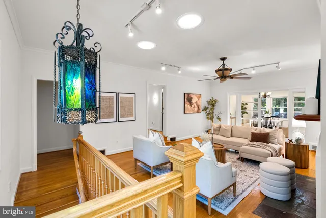 a living room with furniture and a chandelier