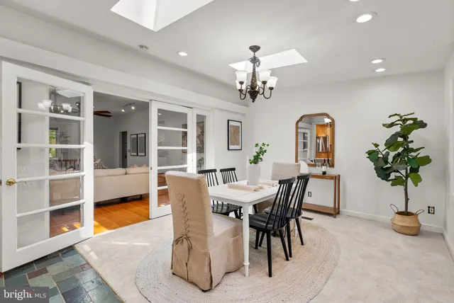 a view of a dining room with furniture and a potted plant