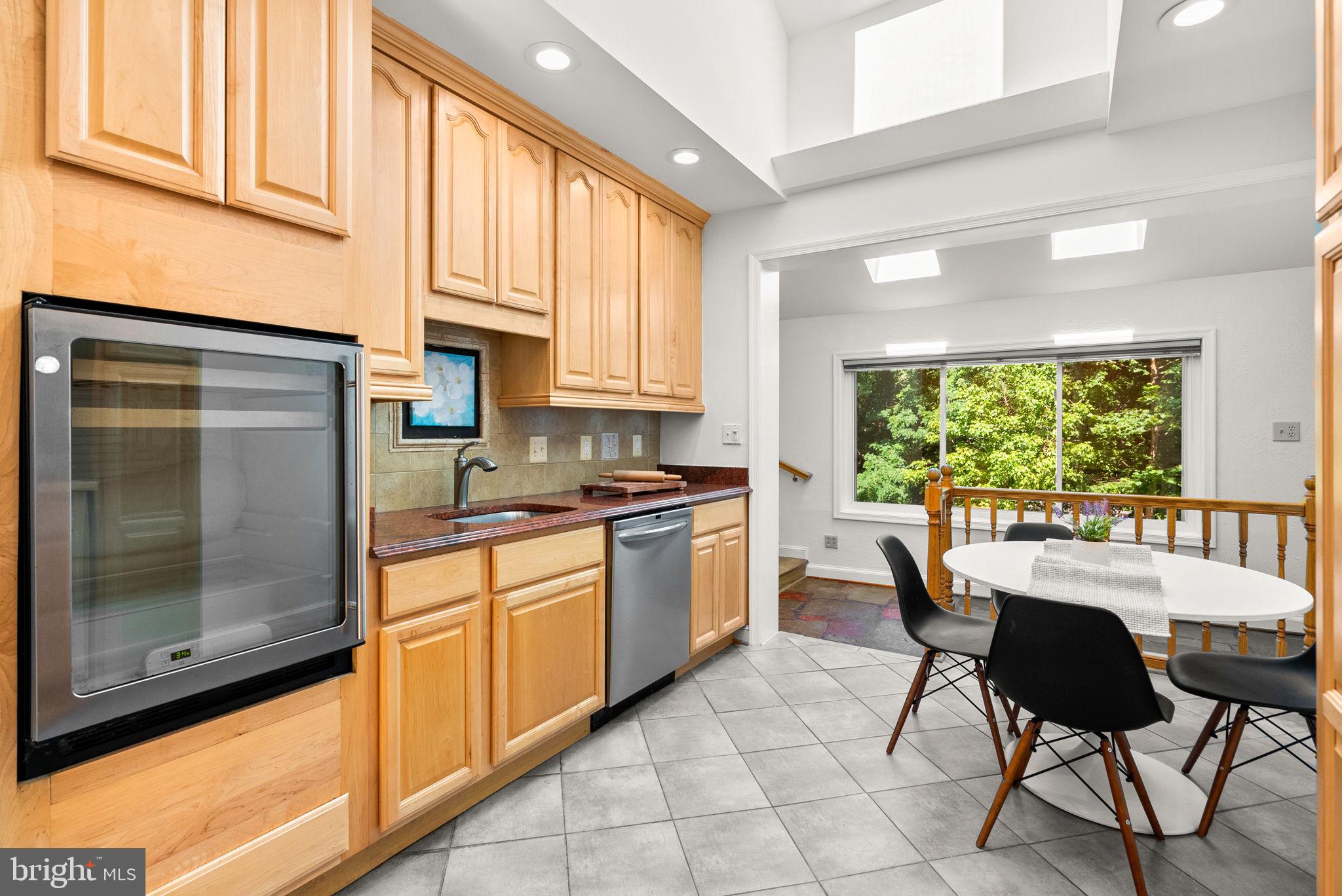2816 Linden Lane Silver Spring, MD 20910 - Photo 10 of 62 a kitchen with a dining table chairs and refrigerator