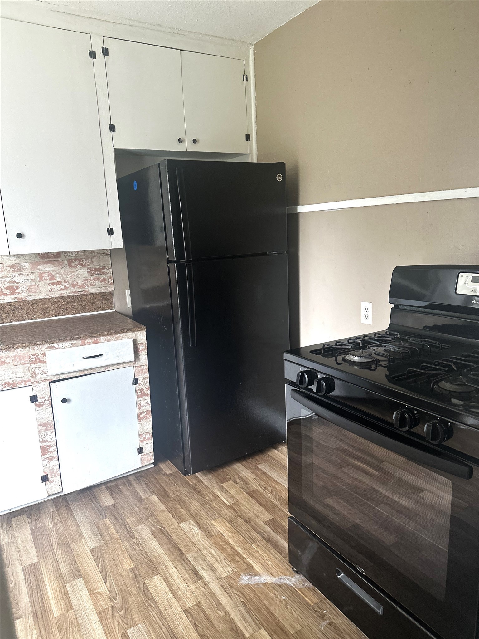 11005 Muscatine Street Houston, TX 77029 - Photo 7 of 12 a kitchen with a stove and a refrigerator