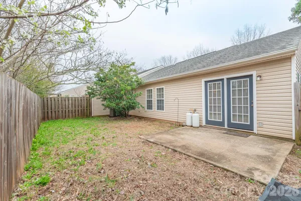 a view of a house with a backyard and floor to ceiling window