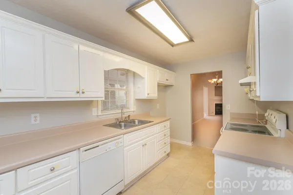a kitchen with sink and cabinets
