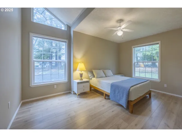 a spacious bedroom with a large bed and a window