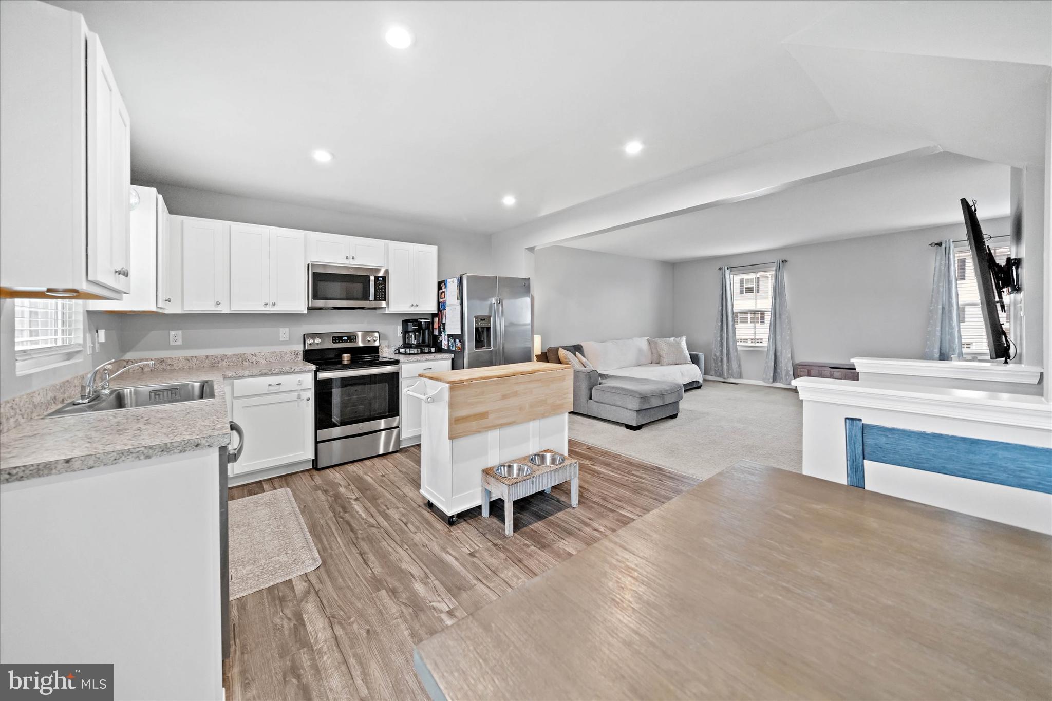 309 Mingo Way Townsend, DE 19734 - Photo 6 of 35 a living room with stainless steel appliances furniture and a kitchen view