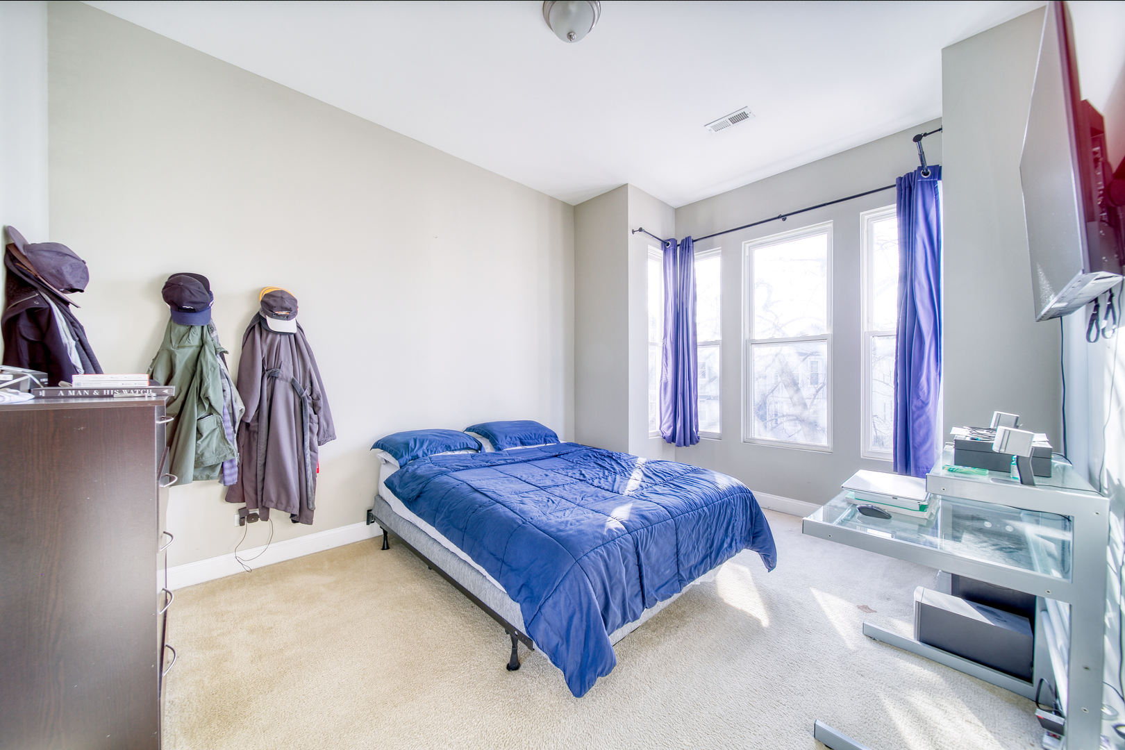 1663 North Richmond Street Chicago, IL 60647 - Photo 16 of 29 a spacious bedroom with a bed and a chandelier