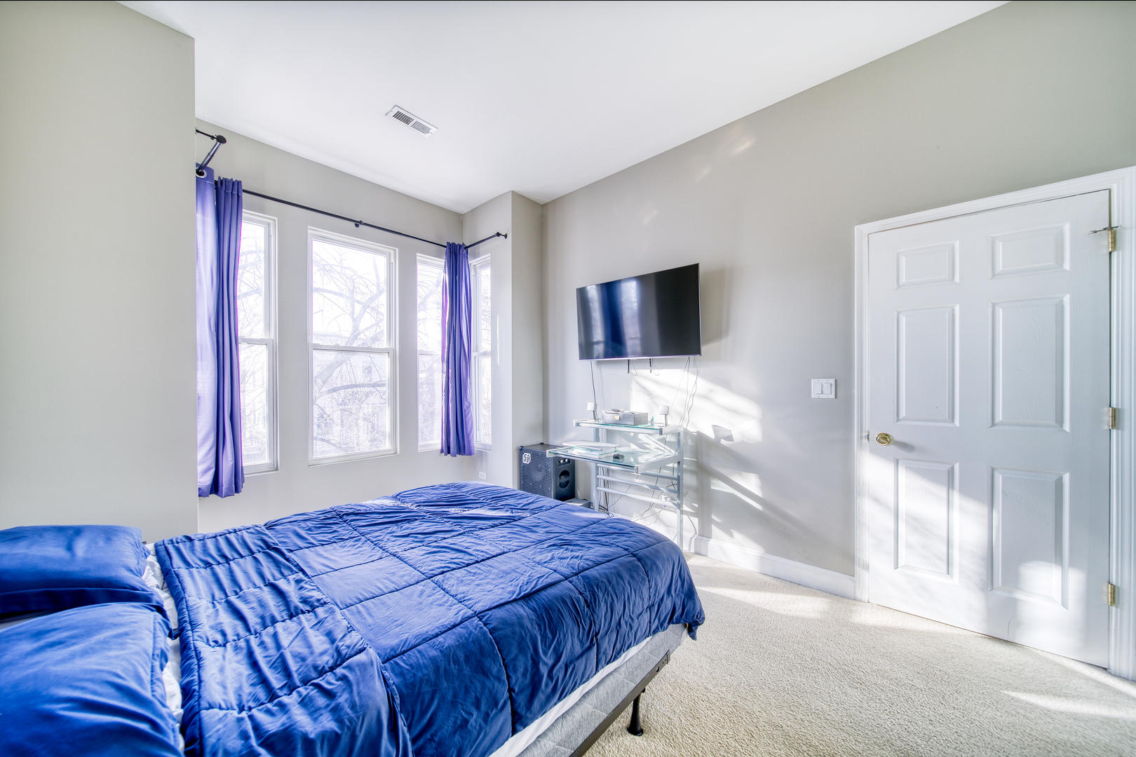 1663 North Richmond Street Chicago, IL 60647 - Photo 17 of 29 a bedroom with a large bed and a flat tv screen on dresser
