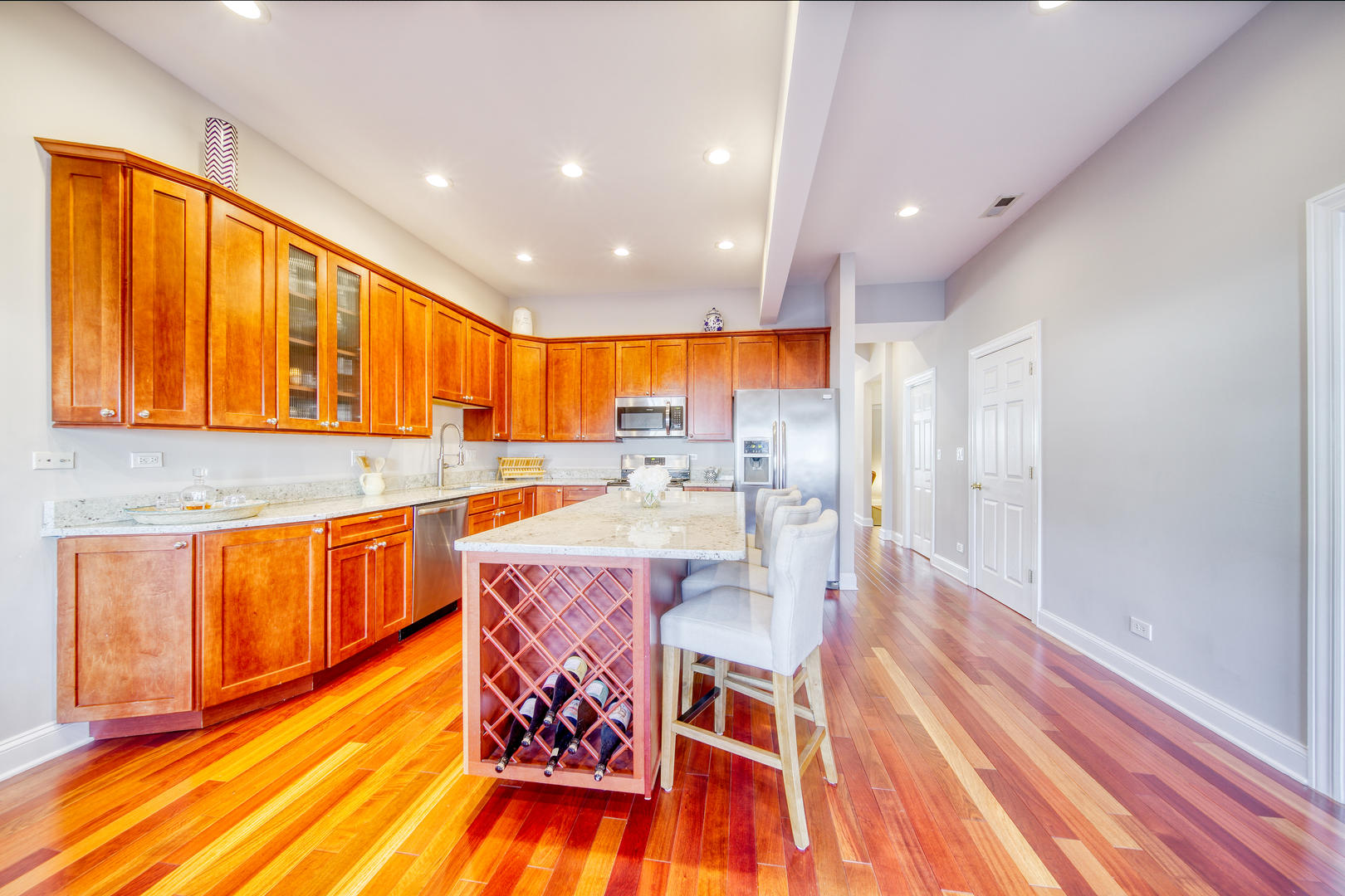 1663 North Richmond Street Chicago, IL 60647 - Photo 9 of 29 a kitchen with stainless steel appliances kitchen island granite countertop wooden floors and a sink