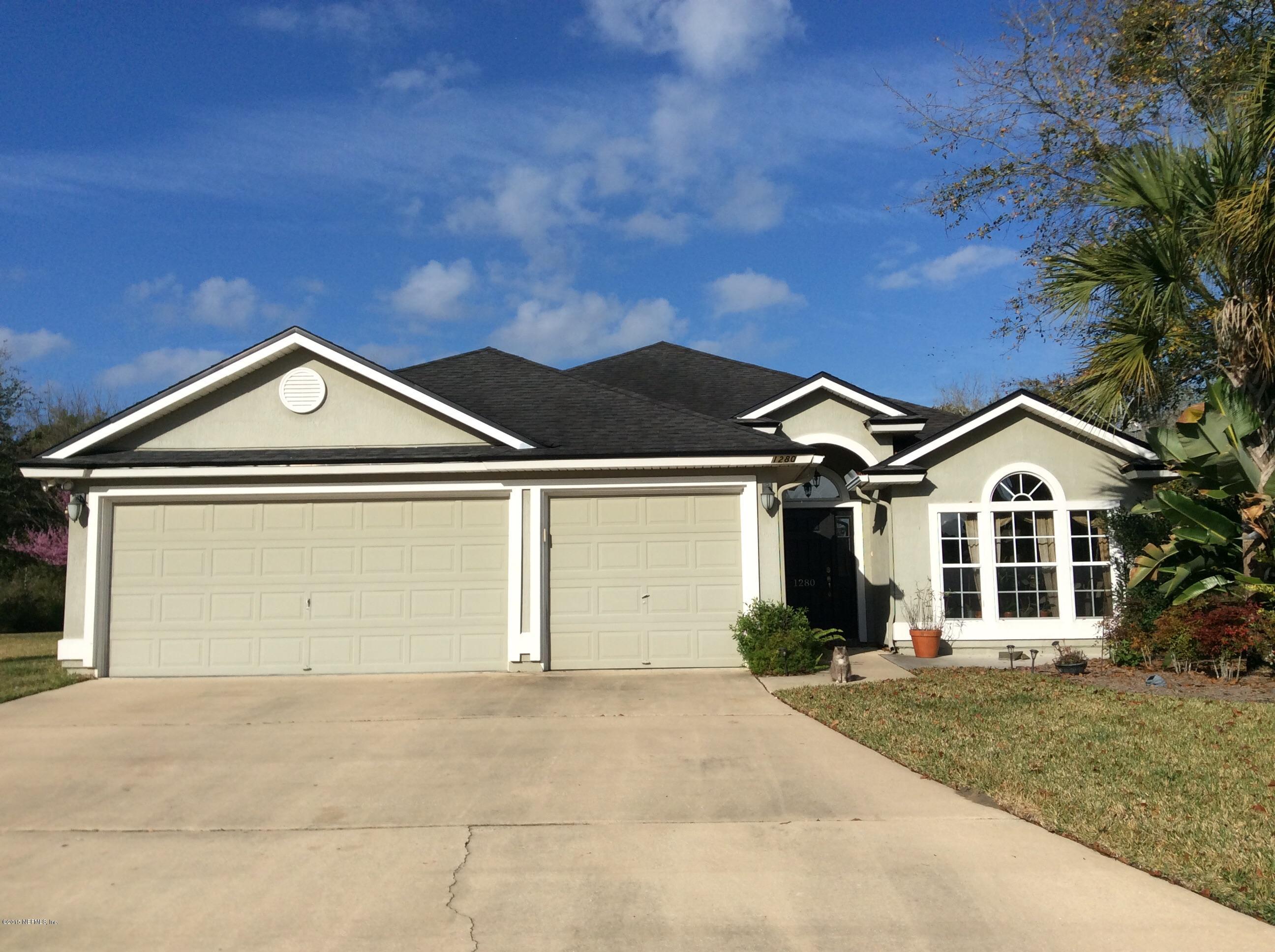 1280 Ribbon Road Jacksonville, FL 32259 - Photo 1 of 1 a front view of a house with a yard and garage