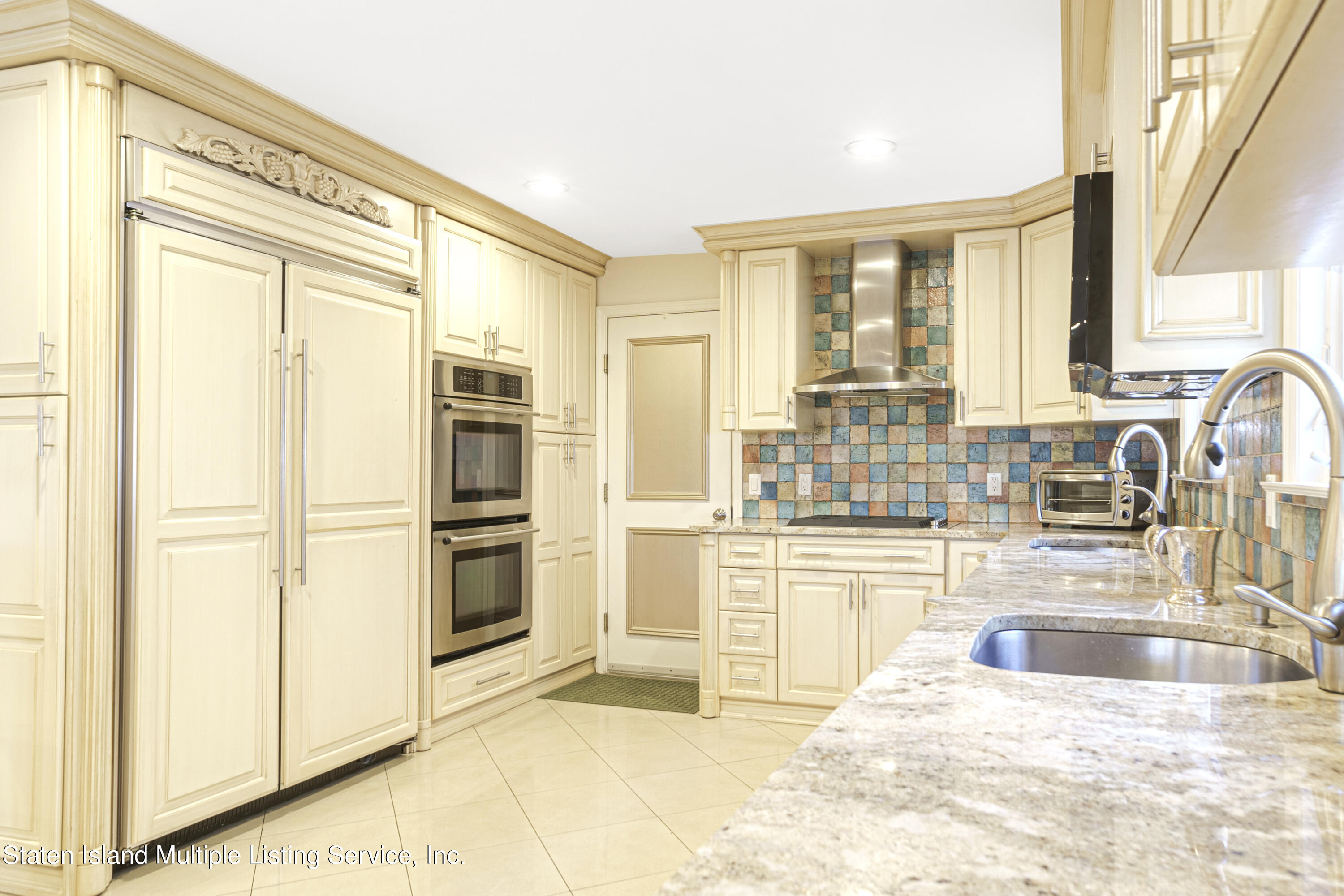 19 Bascom Place Staten Island, NY 10314 - Photo 12 of 54 a kitchen with stainless steel appliances granite countertop a refrigerator and a sink