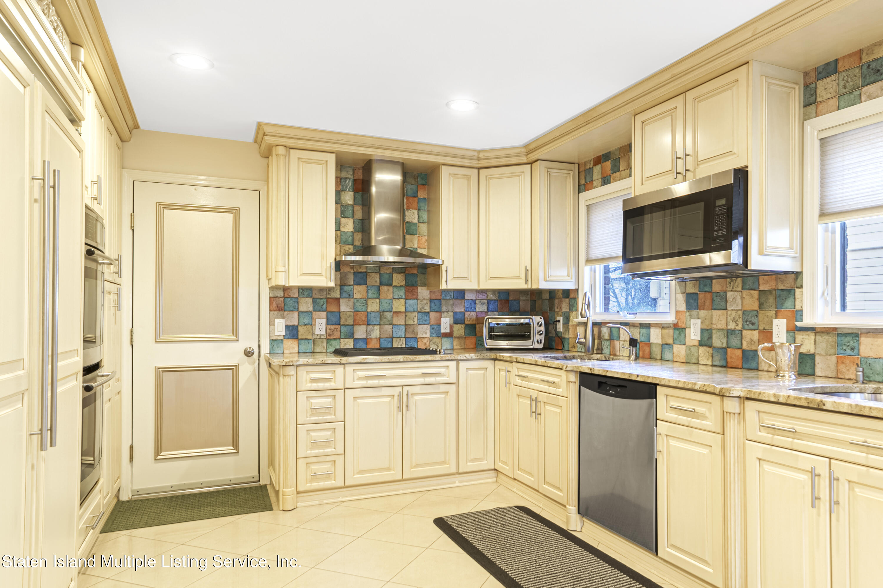 19 Bascom Place Staten Island, NY 10314 - Photo 13 of 54 a kitchen with stainless steel appliances granite countertop a stove and a sink