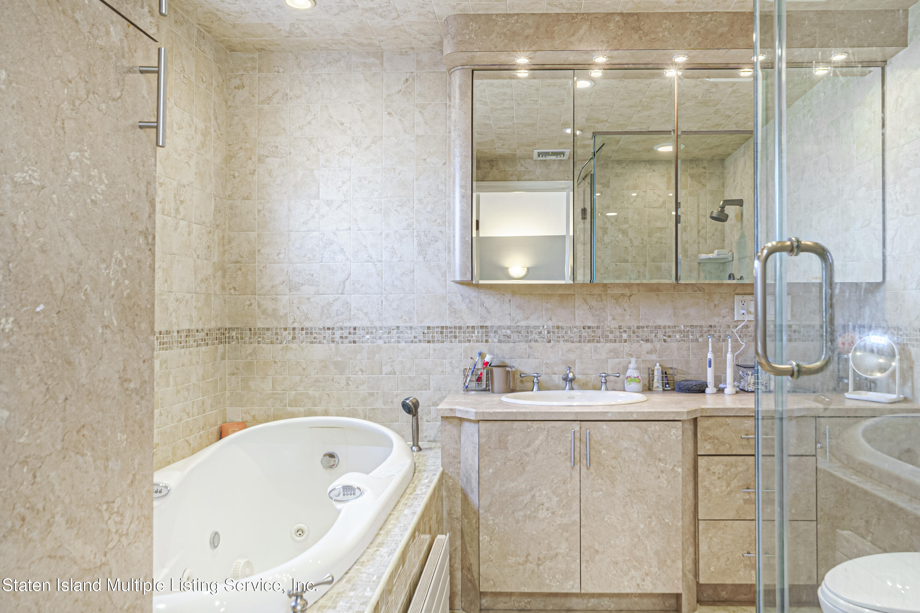 19 Bascom Place Staten Island, NY 10314 - Photo 22 of 54 a bathroom with a sink a toilet and shower