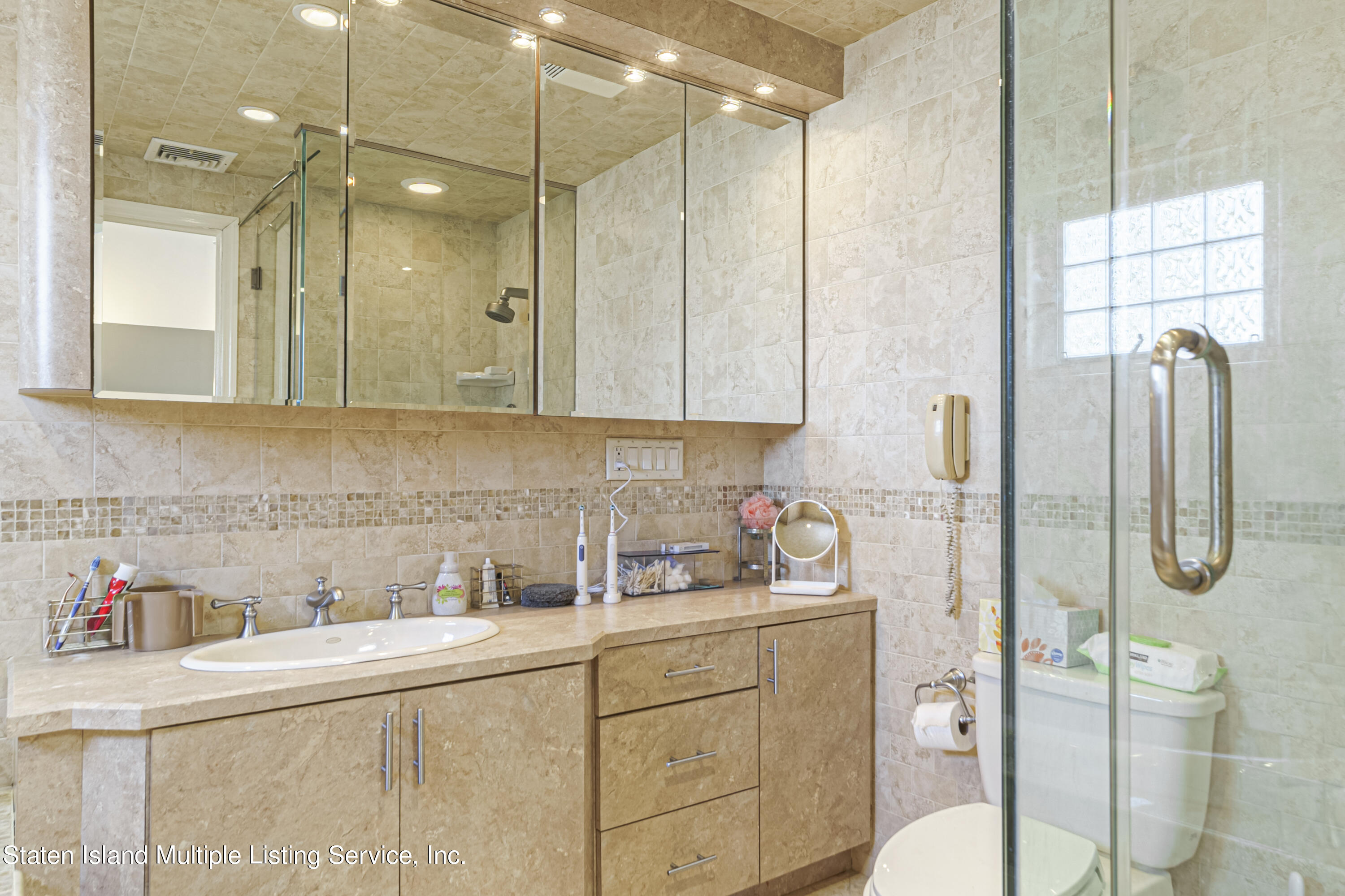 19 Bascom Place Staten Island, NY 10314 - Photo 23 of 54 a bathroom with a granite countertop sink a toilet and shower