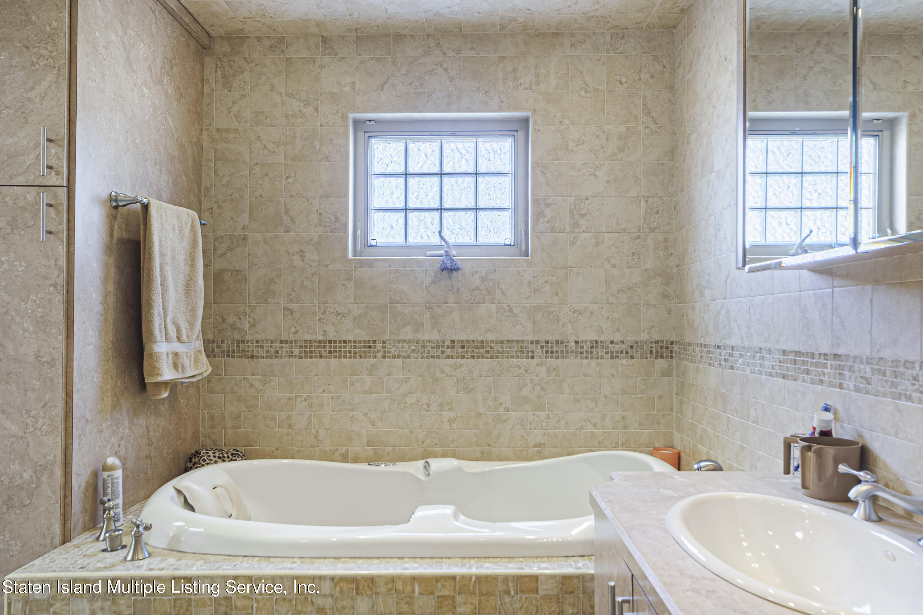 19 Bascom Place Staten Island, NY 10314 - Photo 24 of 54 a bathroom with a tub sink and window