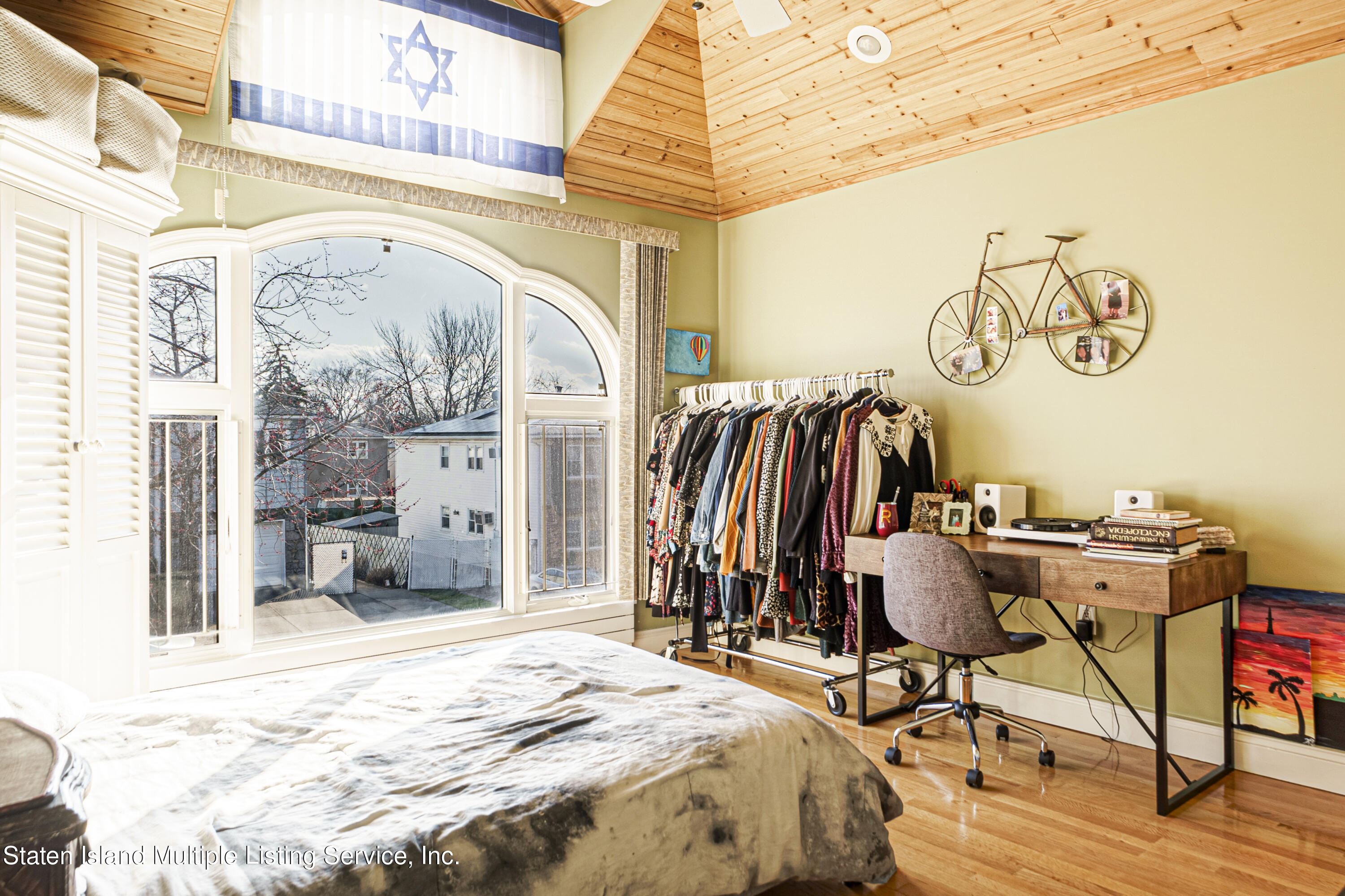 19 Bascom Place Staten Island, NY 10314 - Photo 27 of 54 a bed sitting in a bedroom next to a window