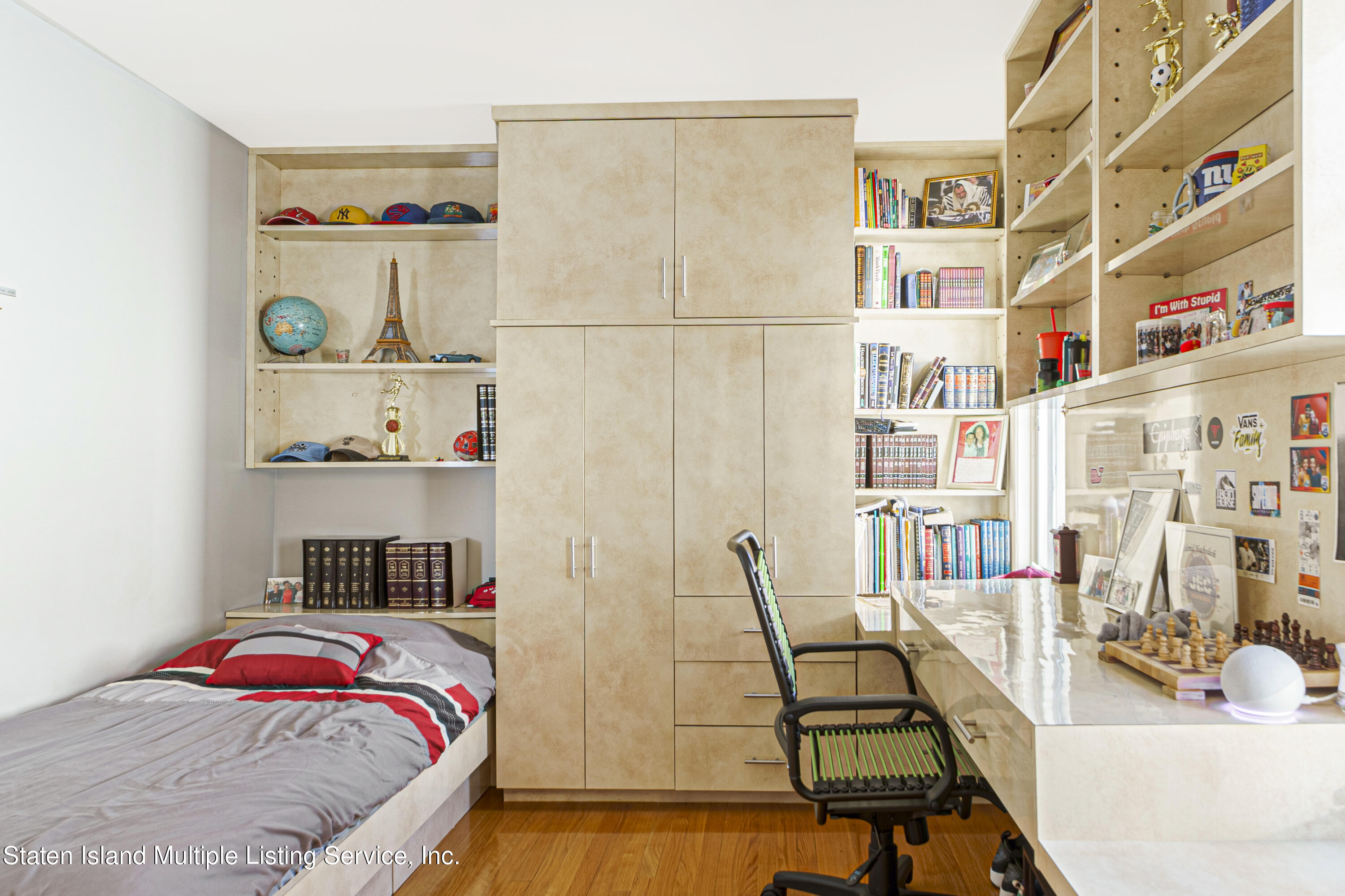 19 Bascom Place Staten Island, NY 10314 - Photo 30 of 54 a bedroom with furniture and a book shelf