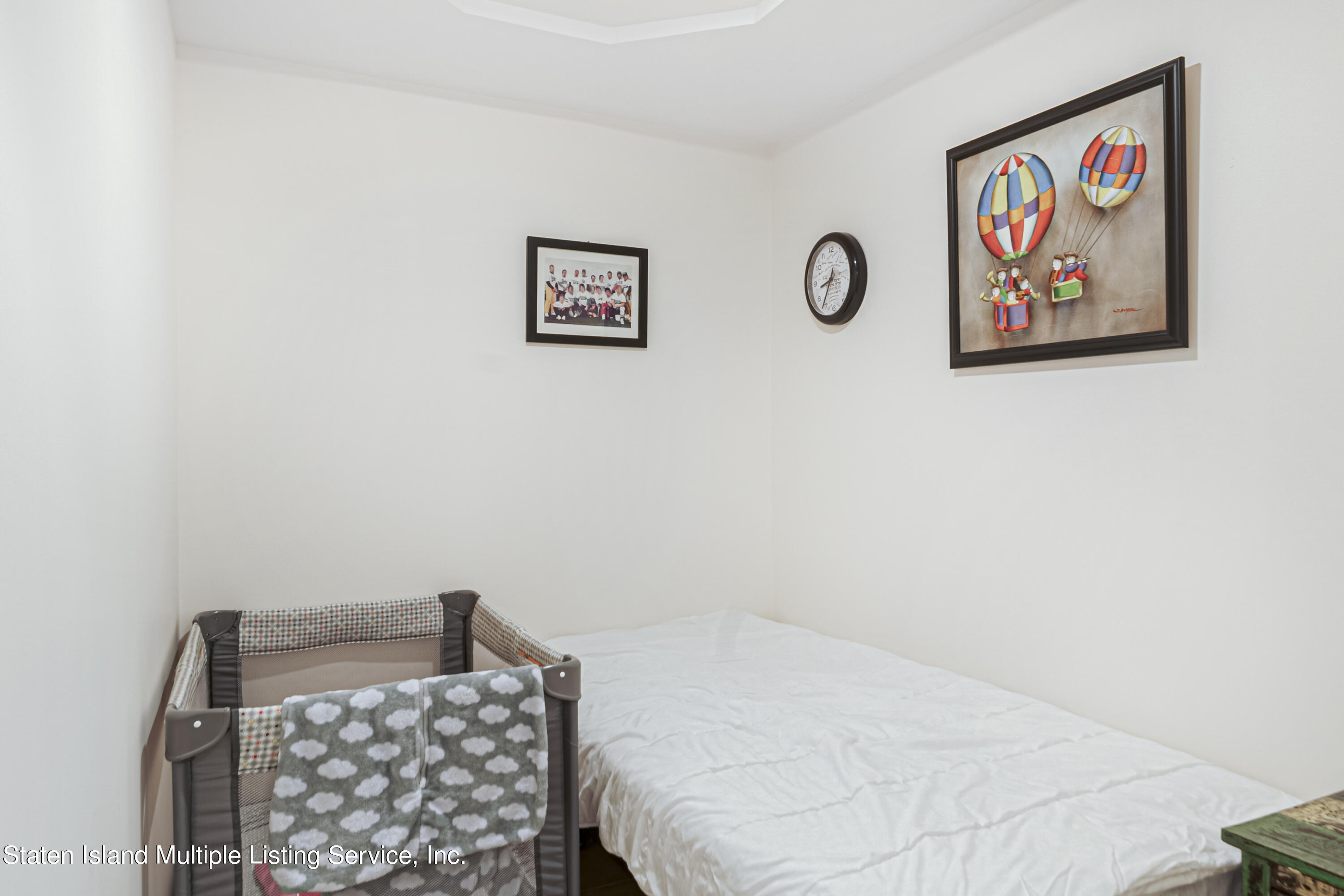 19 Bascom Place Staten Island, NY 10314 - Photo 41 of 54 a bedroom with a bed and a wall painting