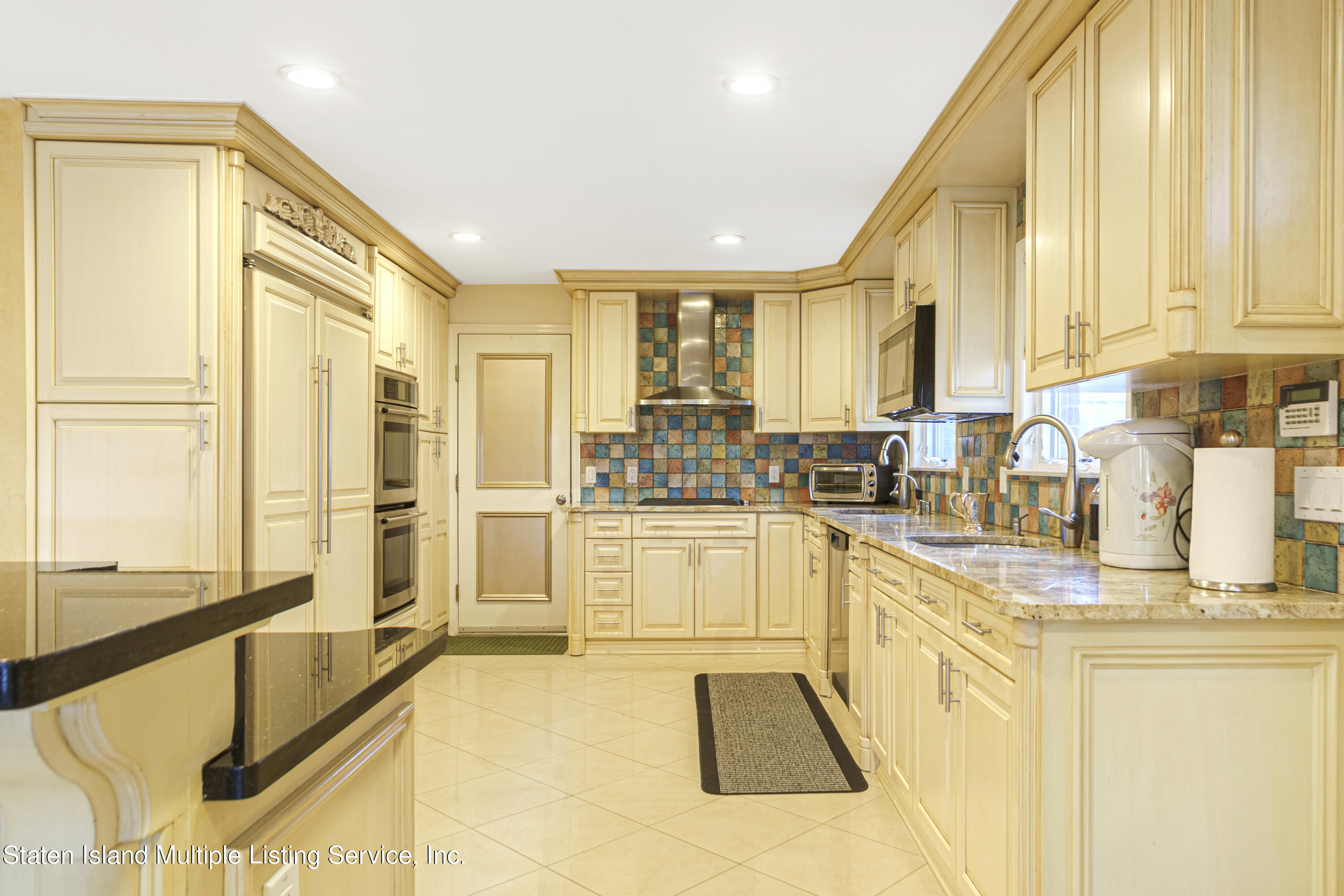 19 Bascom Place Staten Island, NY 10314 - Photo 10 of 54 a large white kitchen with granite countertop a sink and a window