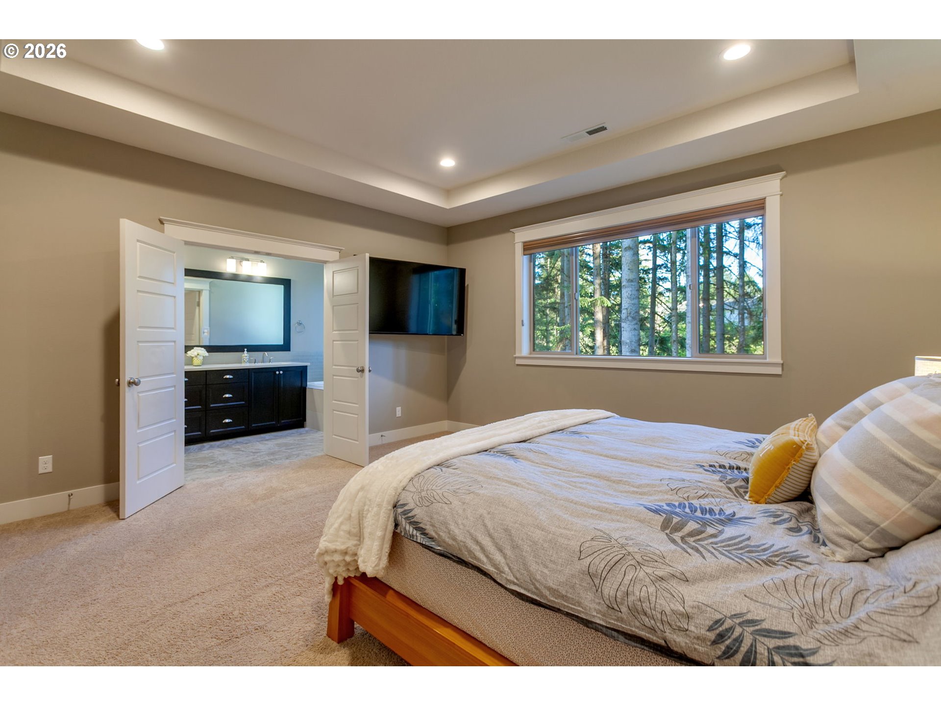 14390 Southwest Fox Lane Beaverton, OR 97008 - Photo 28 of 47 a bedroom with a large bed and a tv