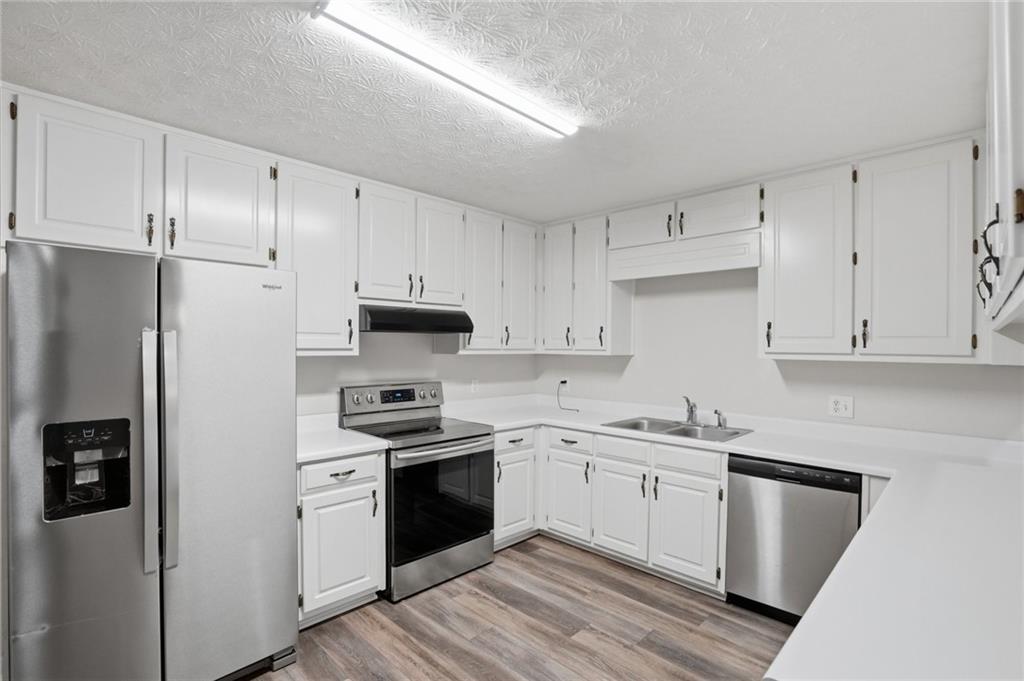 314 Coady Road Jackson, GA 30233 - Photo 8 of 31 a kitchen with stainless steel appliances granite countertop white cabinets a sink a stove a refrigerator and white cabinets