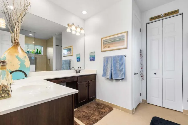 a spacious bathroom with a sink double vanity and a mirror