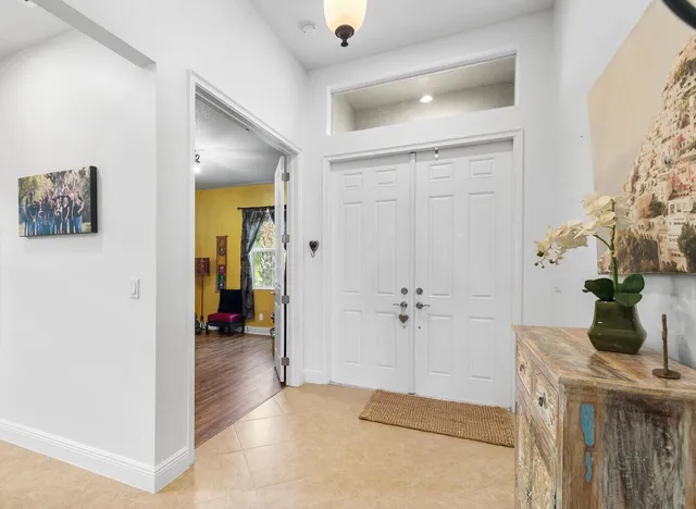 a hallway with beautiful frames and flower vase