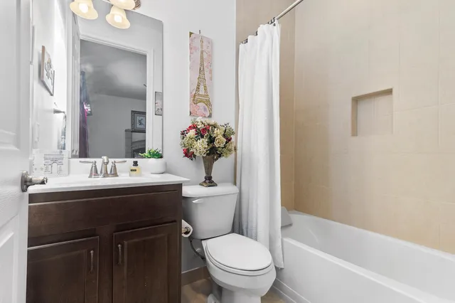 a bathroom with a sink vanity mirror and toilet