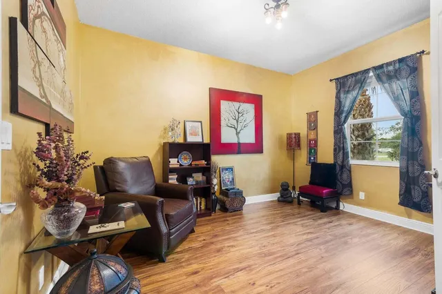 a living room with furniture and a floor to ceiling window